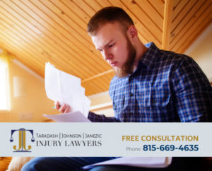 man looking at papers call 815-669-4635 for a free consultation